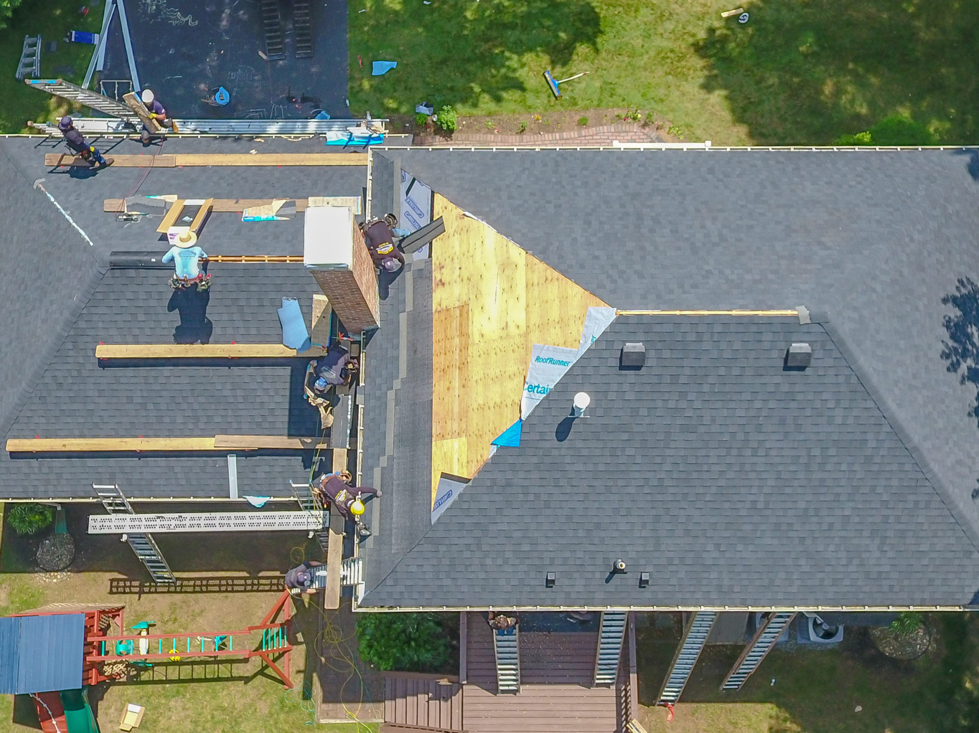 Aerial view of a new roof being installed.