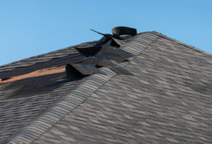 A damaged shingle roofing system.